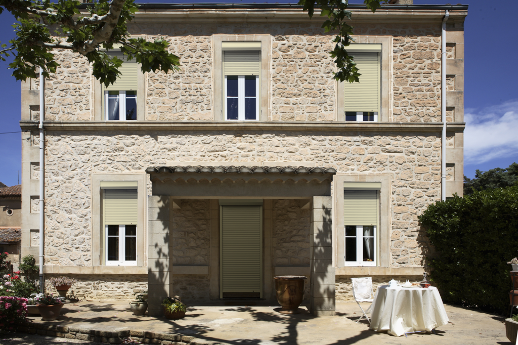 Volets roulants en aluminium de couleur crème installés sur des fenêtres à double vitrage.